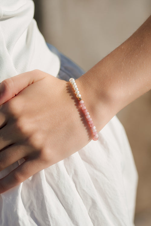 Model wearing the Balance Bracelet with freshwater pearls and pink jade.