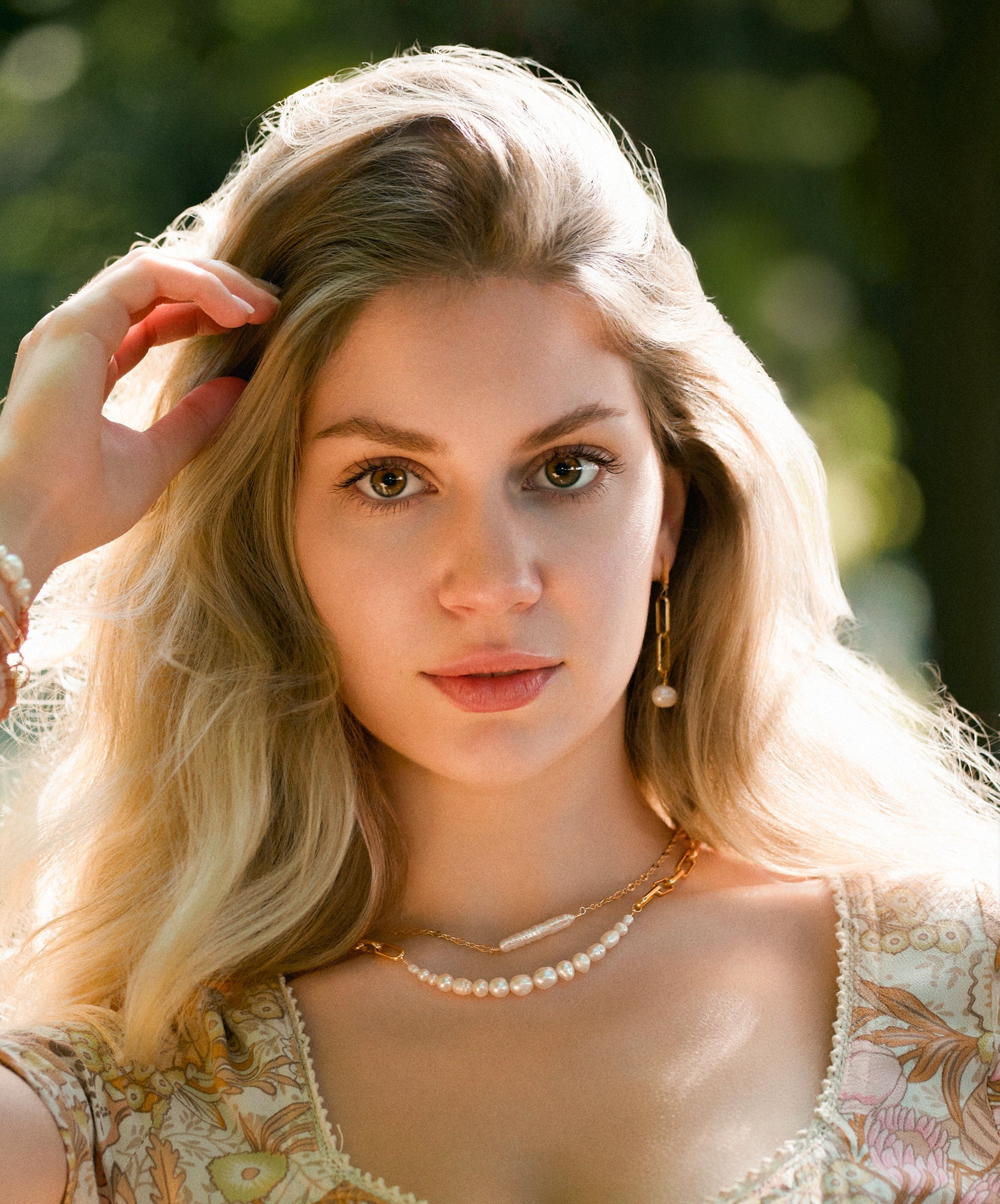 model wearing 2 still wild freshwater pearl and gold fill necklaces, one bolder one delicate and sbutle 