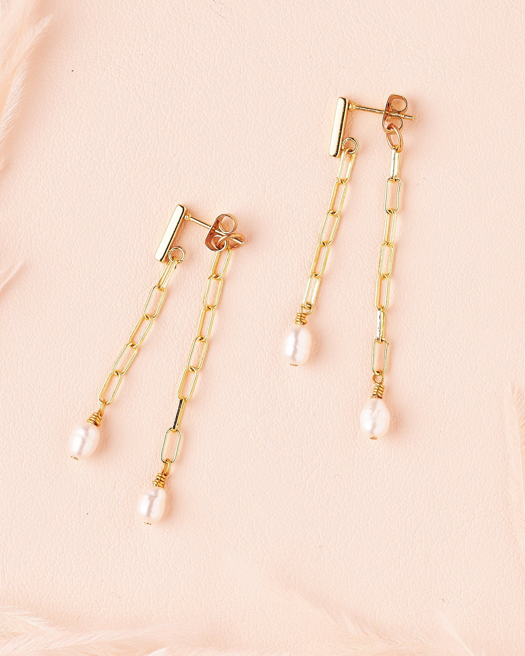 goldfill paperclip chain and freshwater pearls hanging from both sides of ear, earrings by still wild.