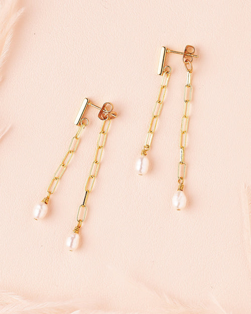 goldfill paperclip chain and freshwater pearls hanging from both sides of ear, earrings by still wild.