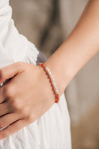 Embrace Bracelet in Fawn styled on wrist, featuring pearl centerpiece with gold-filled and semiprecious stones