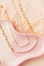 delicate and bold pearl necklaces with gold filled paperclip chains on pink tray 