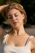 woman wearing 2 delicate pearl and gold filled necklaces