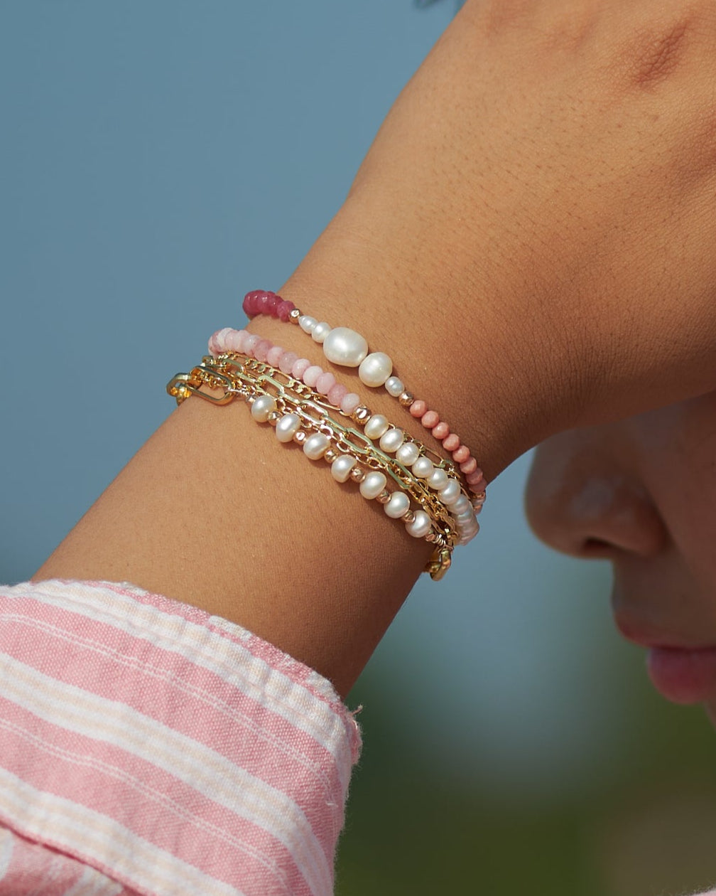 model wearing still wild bracelets, freshwater pearls, semiprecious stones and gold filled 