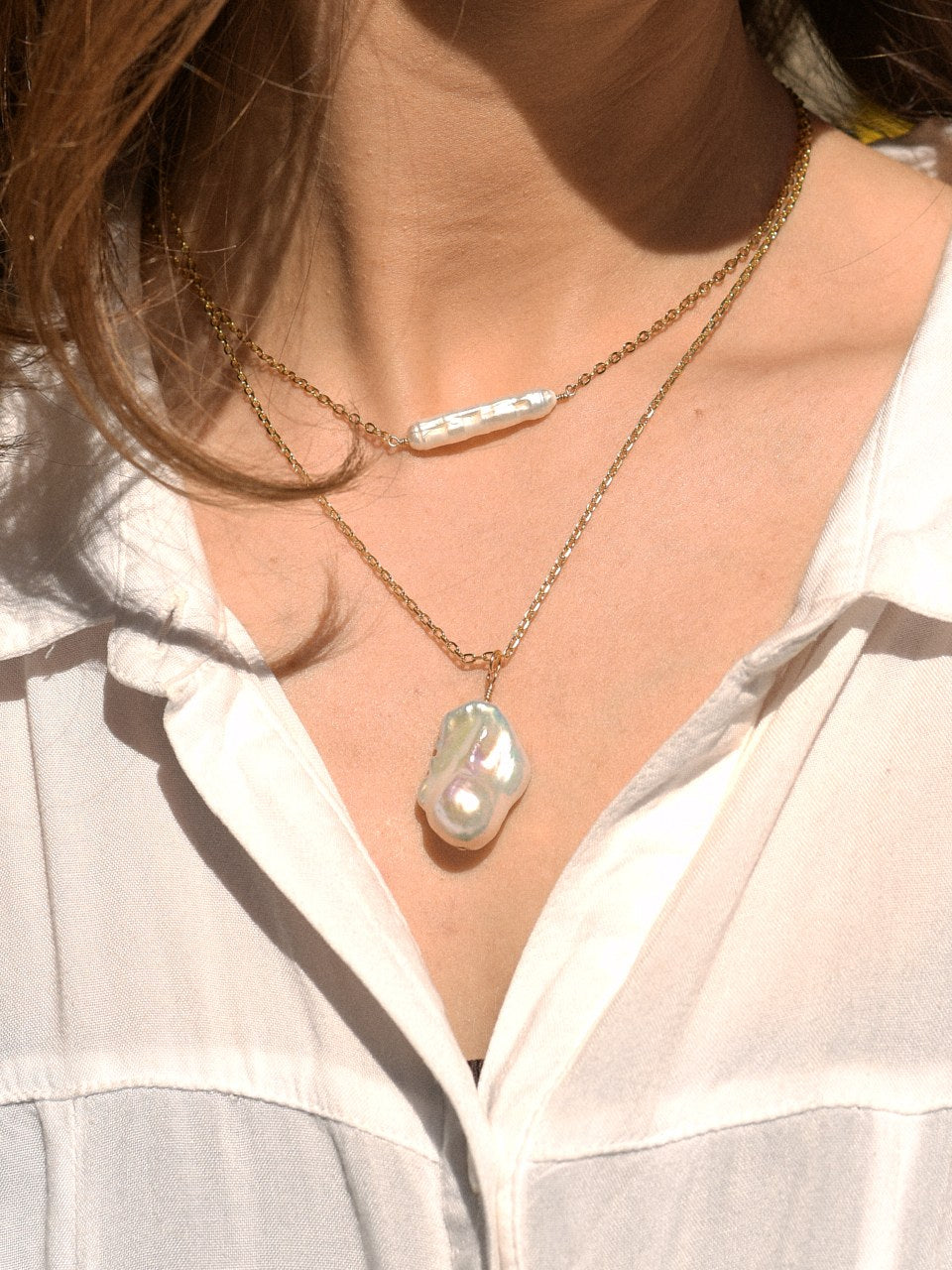 Aura Necklace with a baroque freshwater pearl pendant, layered with the Tide Necklace