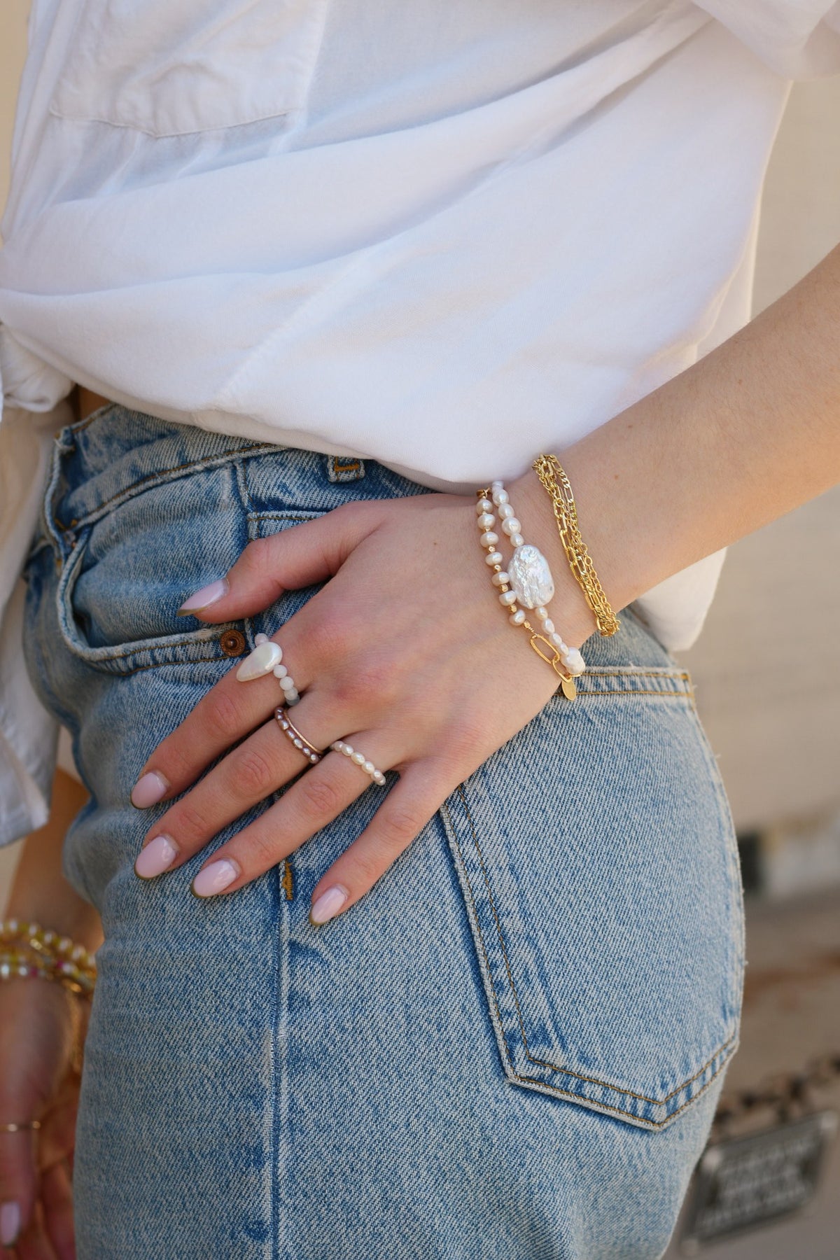 Horizon, Pearl Forte and Aria bracelets stacked, worn with jeans and pearl rings